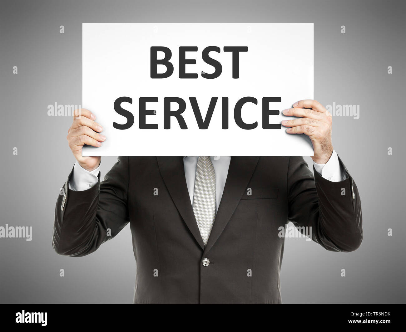 Geschäftsmann mit einem Schild mit der Aufschrift besten Service, Deutschland Stockfoto