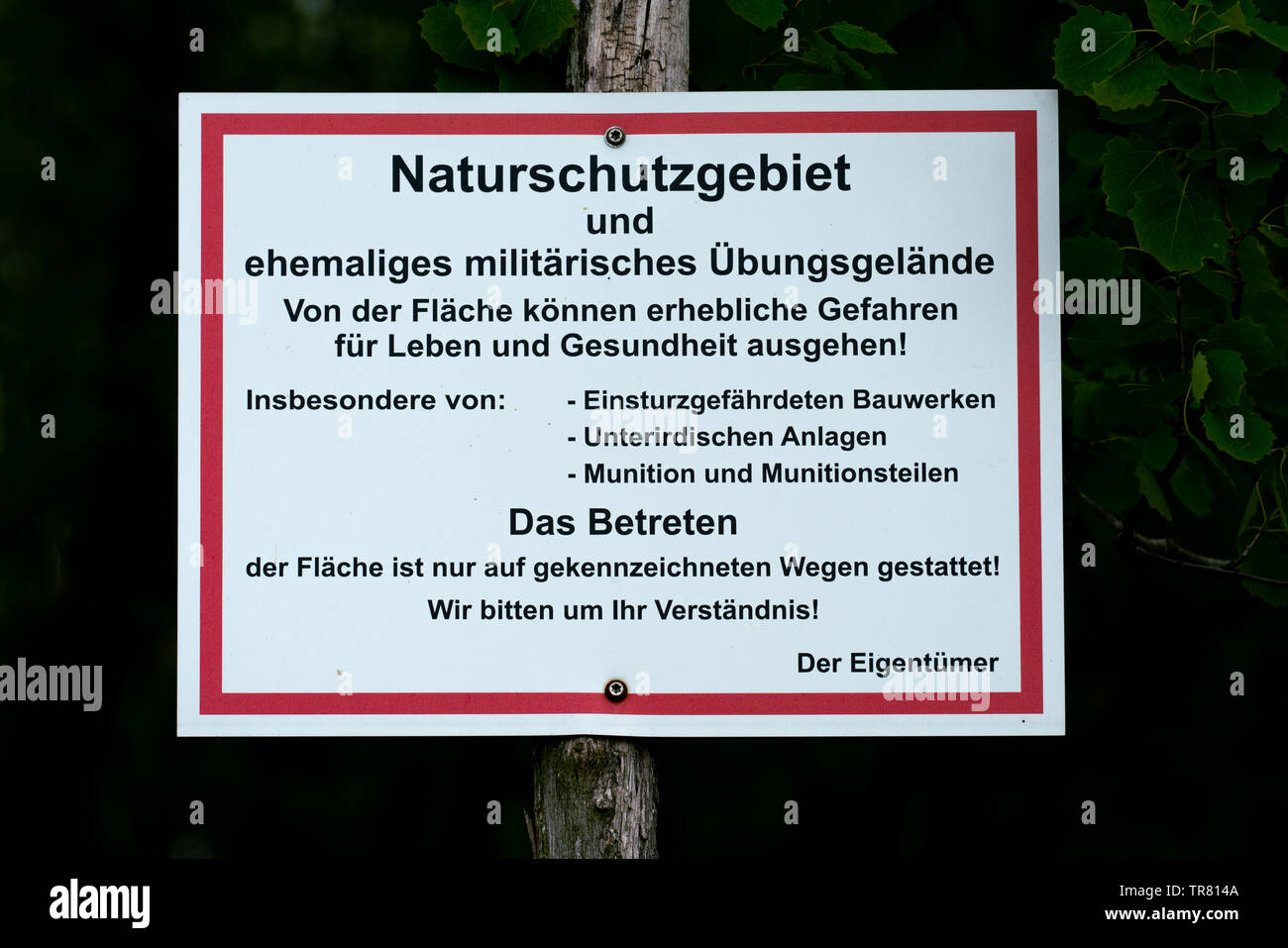 Deutsche Warnschild in einem Naturschutzgebiet nicht abseits der Pfade zu Schritt wegen der Gefahr durch unentdeckte Munition in dieser (ehemaligen) Bereich Stockfoto