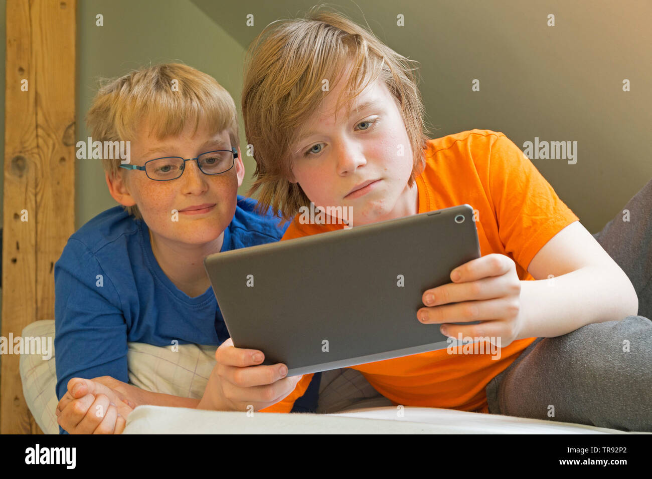 Junge plyaing mit Tablet Computer, sein Freund aufpassen, Deutschland Stockfoto