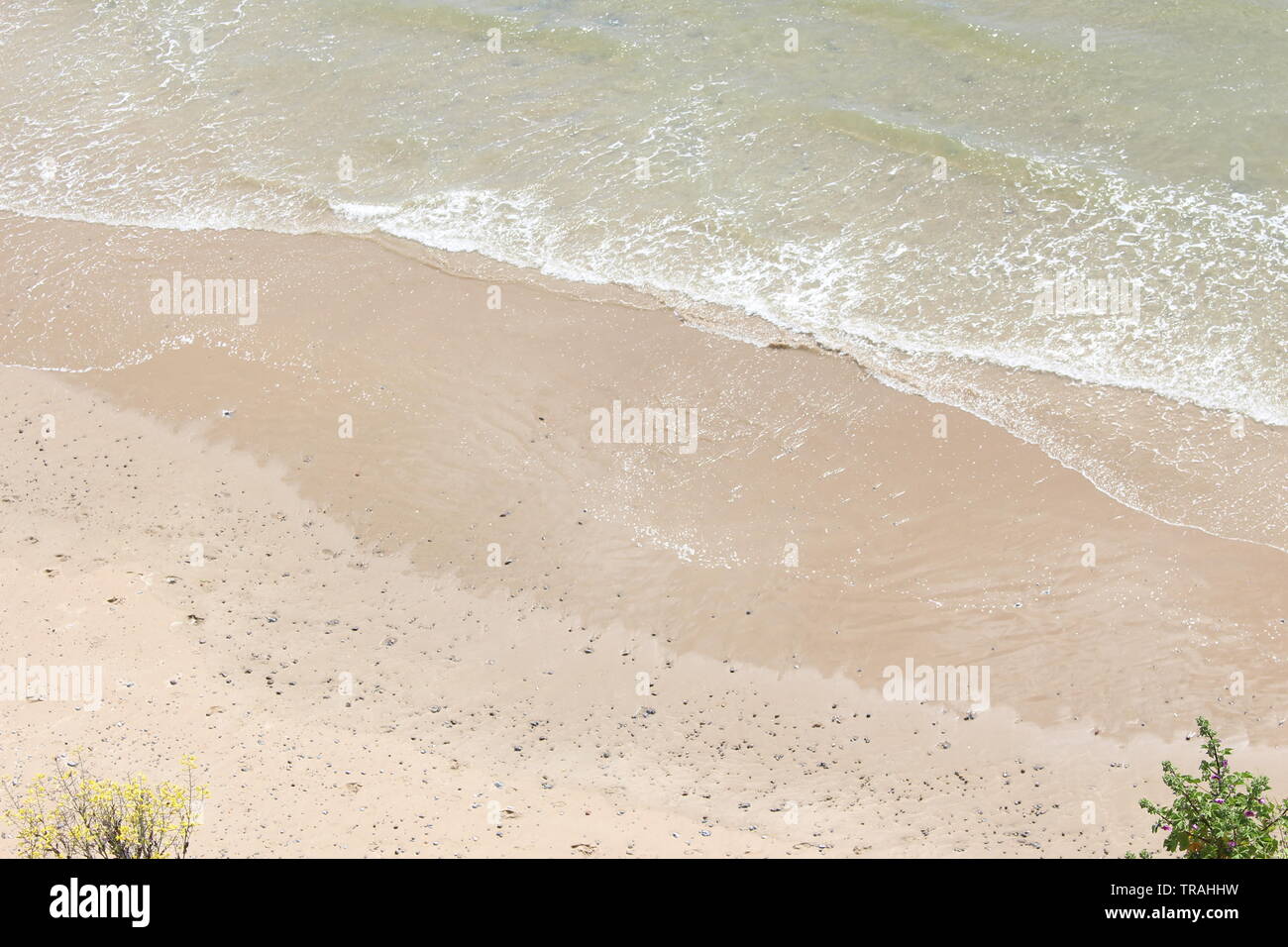Ein Foto von sich hoch an einem Strand und Wellen, An einem hellen Sommertag. Tenby, Pembrokeshire, Wales, Großbritannien Stockfoto