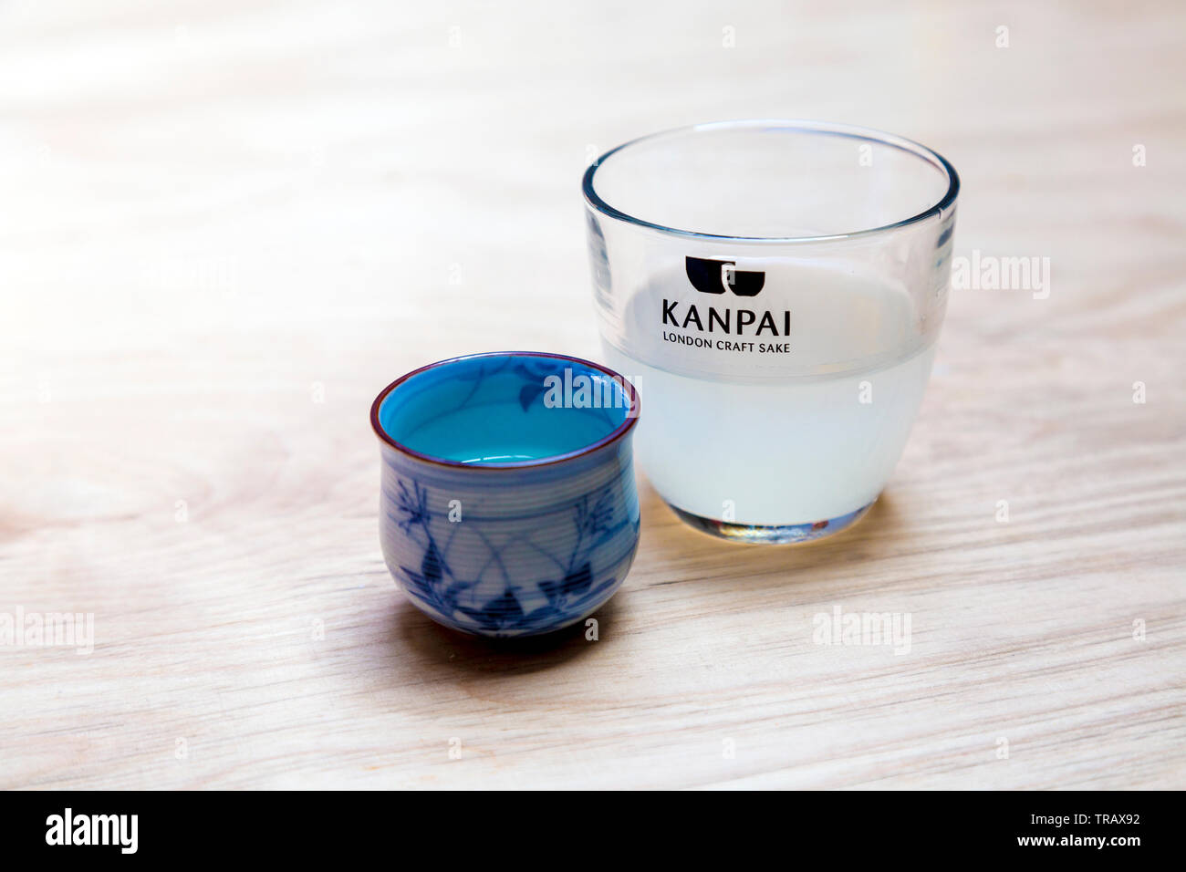 Tassen Handwerk willen an Kanpai auf einem Holztisch - erste Londoner Sake-brauerei, London, UK Stockfoto