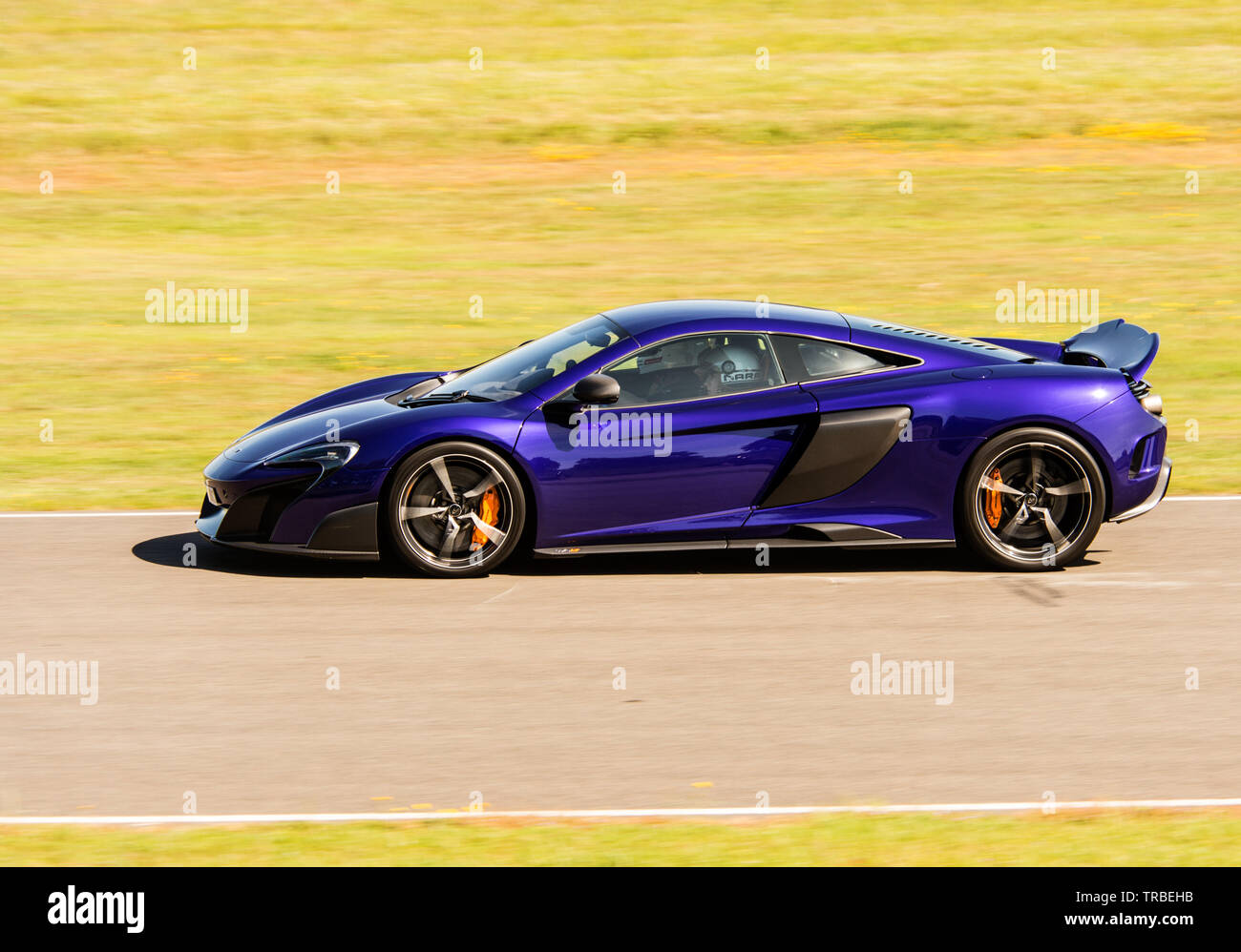 McLaren 675 lt Super Auto, Passagiere runde Goodwood für Nächstenliebe Stockfoto