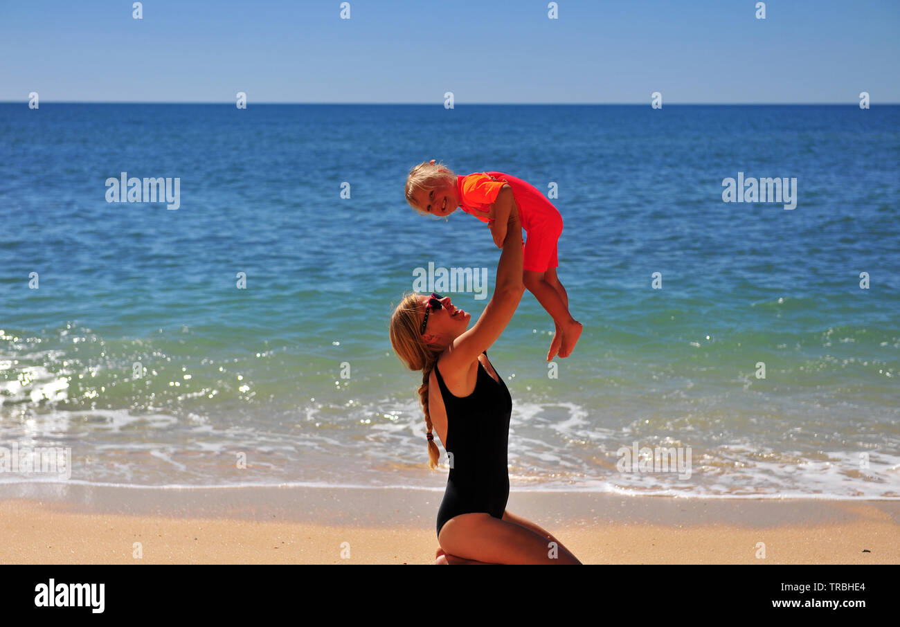 Mutter mit ihrer Tochter auf Sand Beach, Portugal Stockfoto