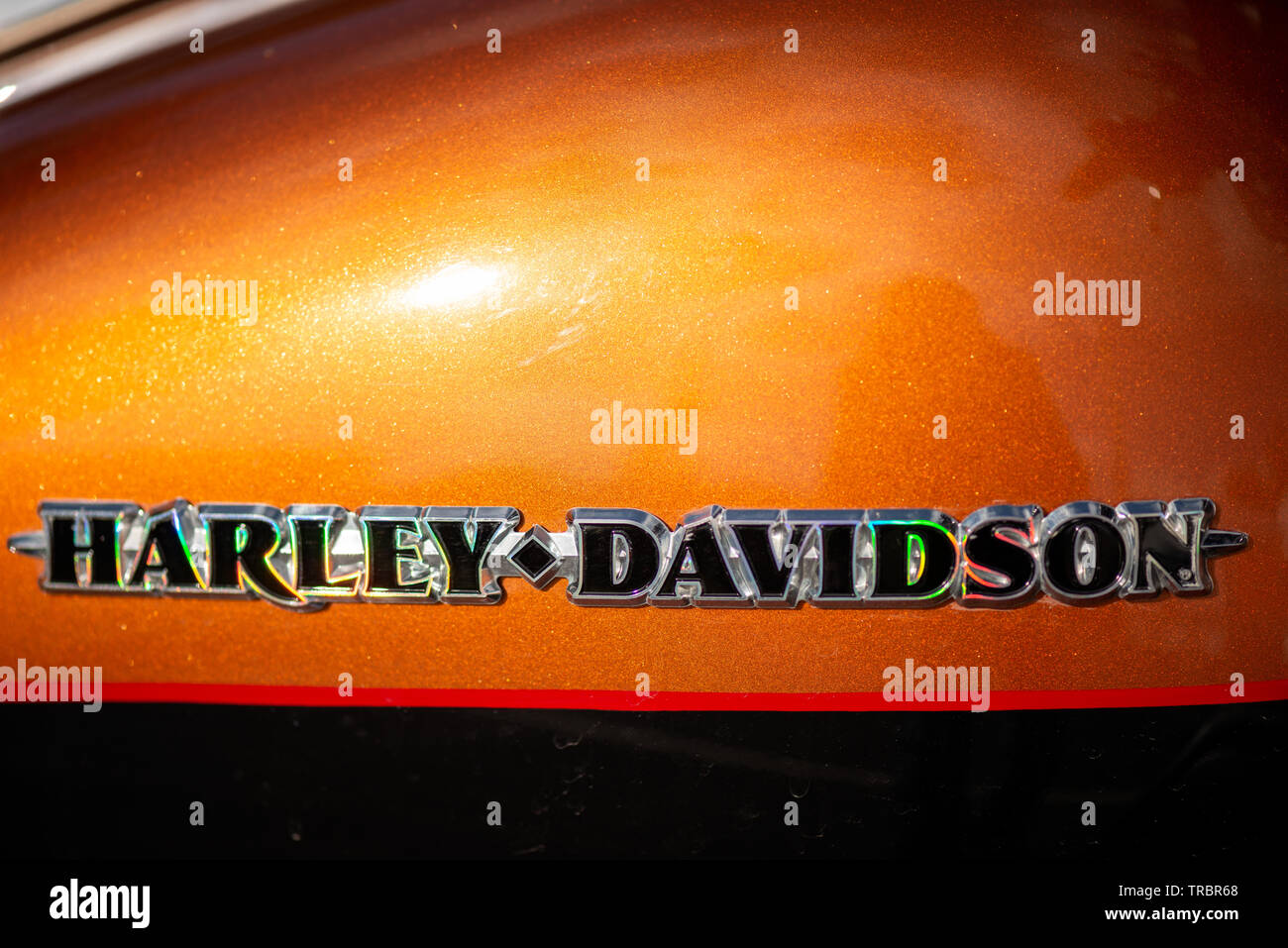 Glitzerndes Harley Davidson Logo auf orangefarbenem Benzin-Tank Stockfoto