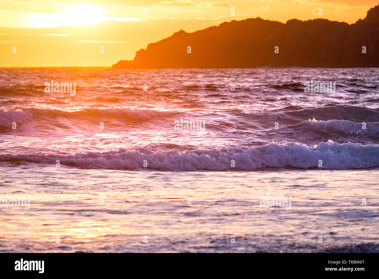 Wellen am Strand bei Sonnenuntergang brechen, Whitesands Bay, St Davids, Pembrokeshire National Park, Wales, Großbritannien Stockfoto
