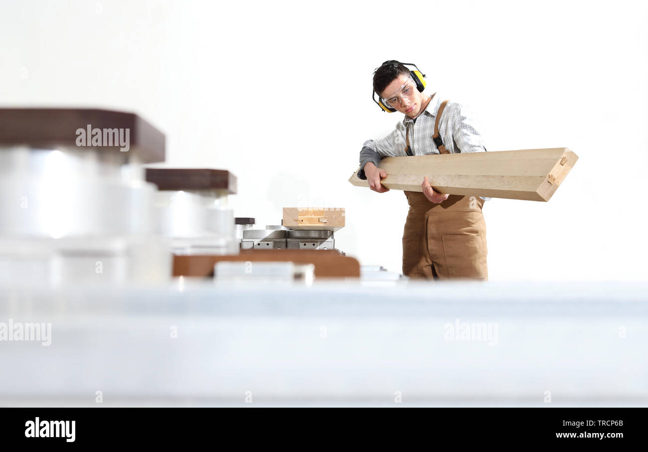 Tischler arbeitet man mit Holzplanken in der Tischlerei, mit Computer Numerical Control Center, CNC-Maschine, auf weißem Hintergrund Stockfoto