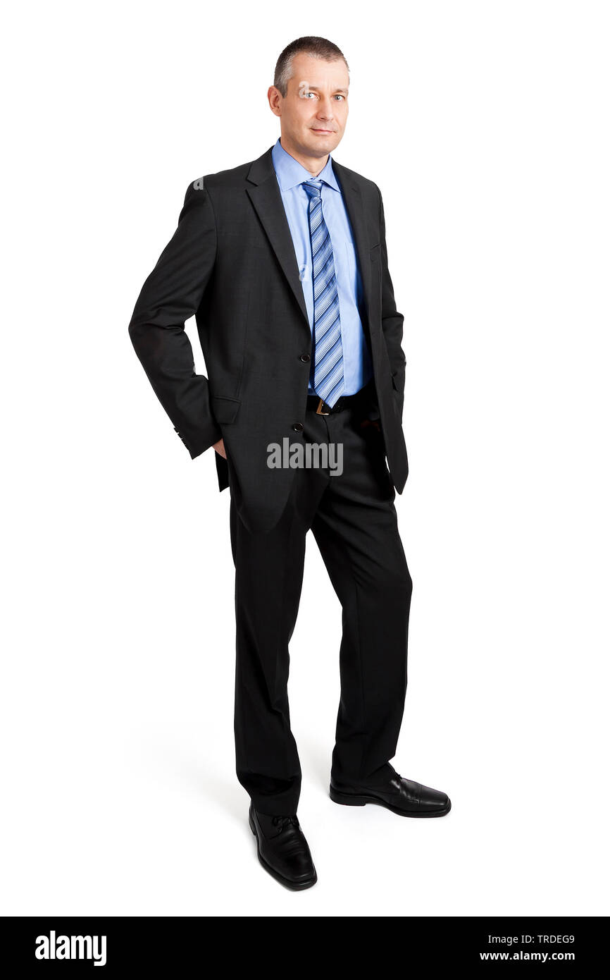 Porträt eines sympathischen Geschäftsmann in einem grauen Anzug mit Händen in den Hosentaschen Stockfoto