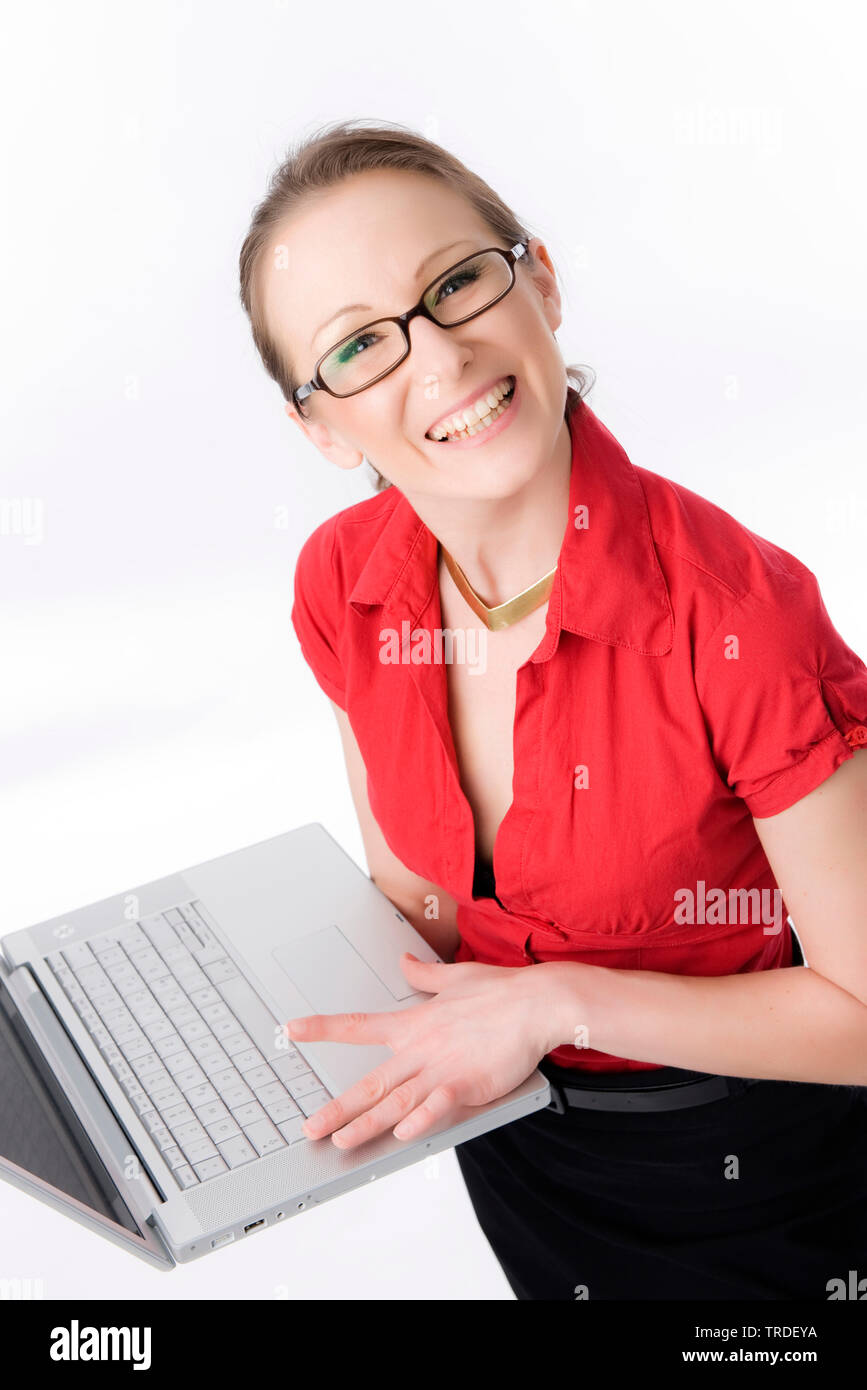Portrait einer jungen sympathischen Business Frau mit einem Laptop und lächelnd in die Kamera Stockfoto