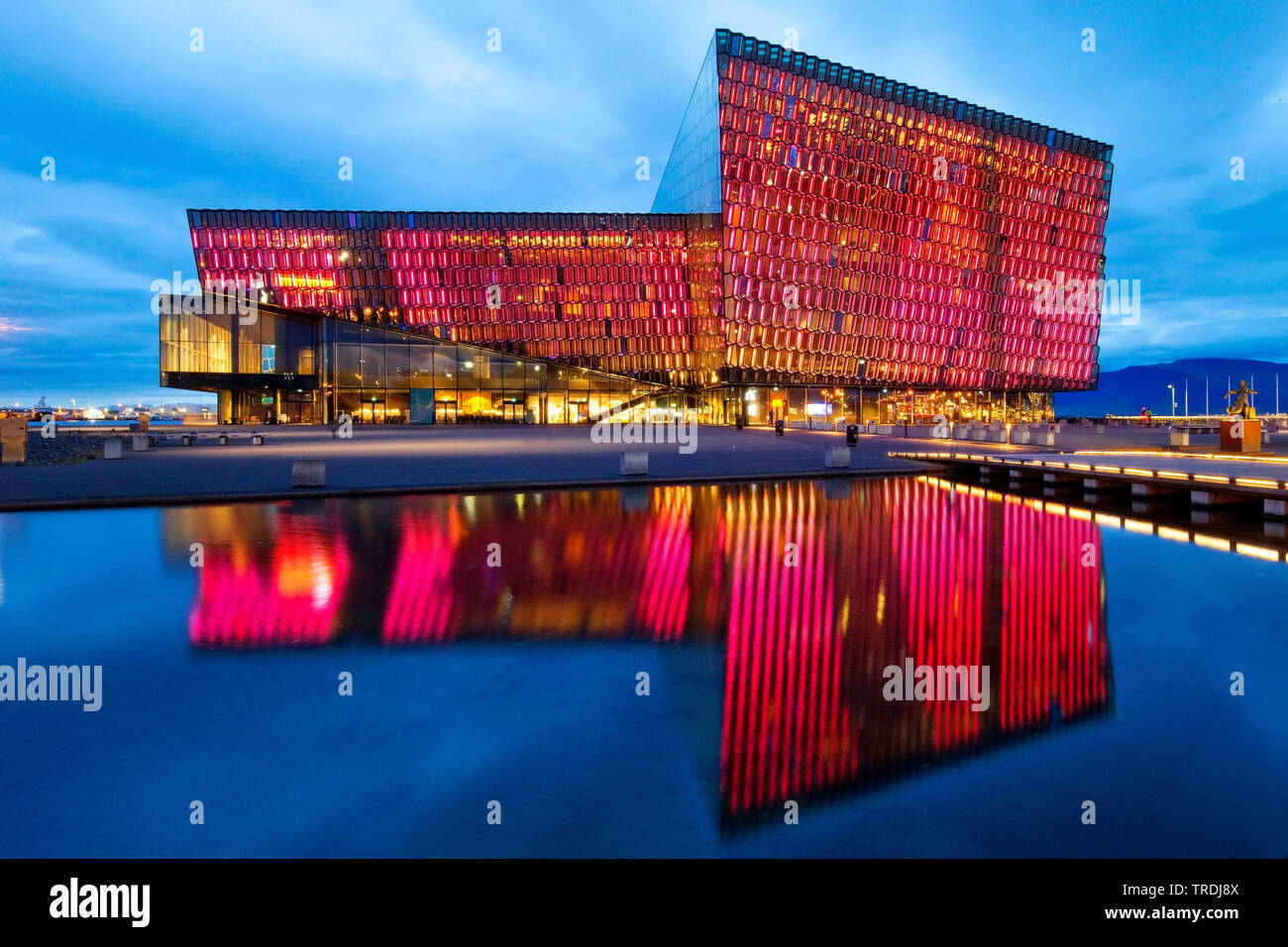 Beleuchtete Harpa Konzertsaal mit markanten farbigen Glas facace am Abend, Island, Reykjavik Stockfoto