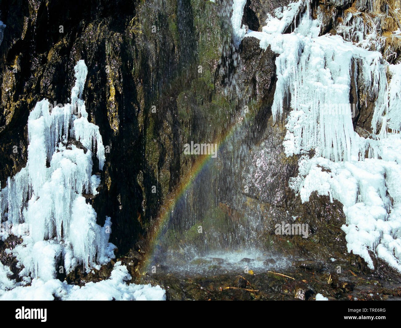 Wasserfall mit Eis und Regenbogen, Deutschland Stockfoto