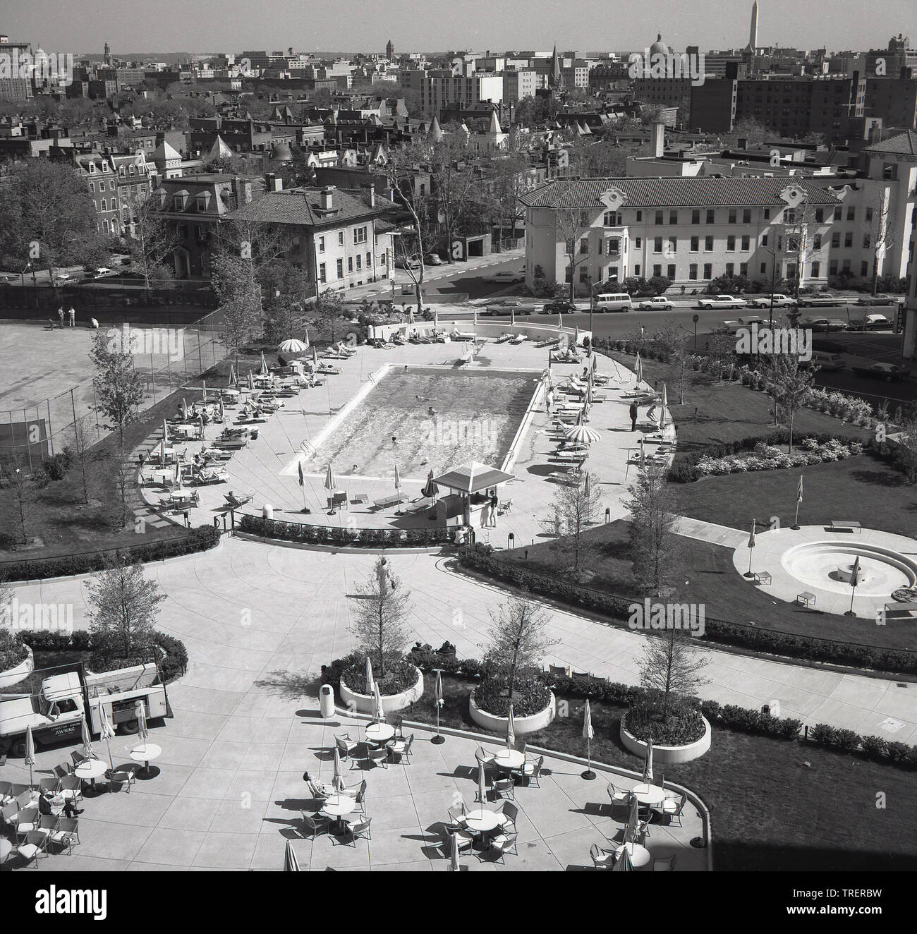 1960s, historische Luftaufnahme der Rückseite des Washington Hilton Hotels, zeigt den Swimmingpool und in der Ferne die Skyline und die Stadt Washington DC, USA. Stockfoto