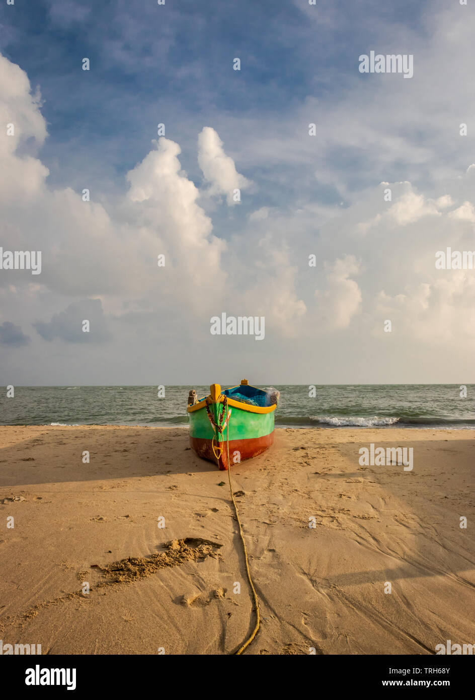 Fischerboot auf den gelben Sandstrand mit Wolken und blauer Himmel bei dhanushkodi rameswaram Indien. Stockfoto