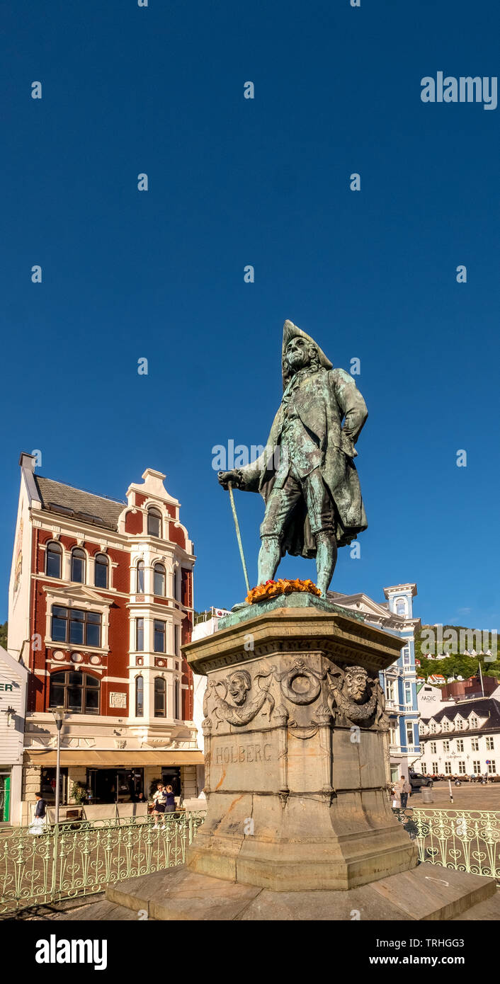 Auf einem steinernen Sockel, die Statue von Ludvig Holberg, Baron von Holberg, mit einem weißen Zaun gerahmt, vor einem strahlend blauen Himmel, um zu sehen, dahinter die Theta Mus Stockfoto