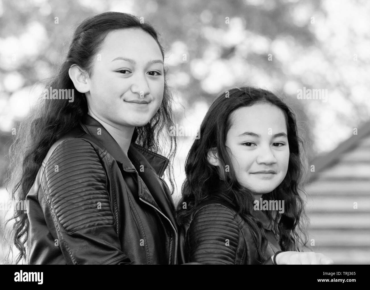 Porträt von zwei jungen Maori Schwestern getroffen, im Freien in einem Park. Stockfoto