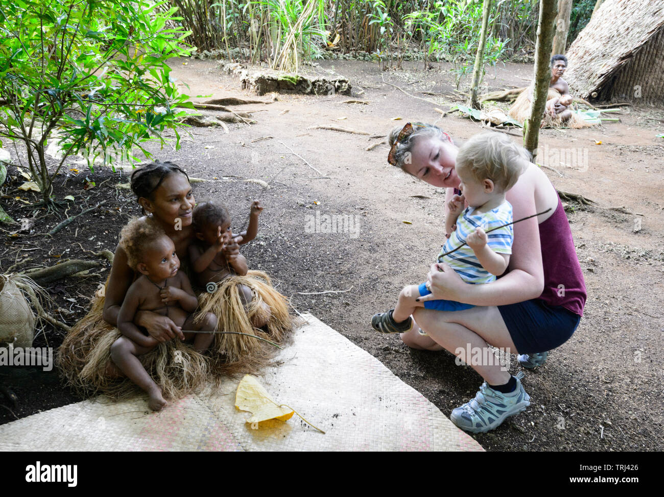 Blond kaukasischen Kleinkind sieht Melanesian tribal junge Kinder, Pepeyo Cultural Village, Port Vila, Efate Island, Vanuatu, Melanesien Stockfoto