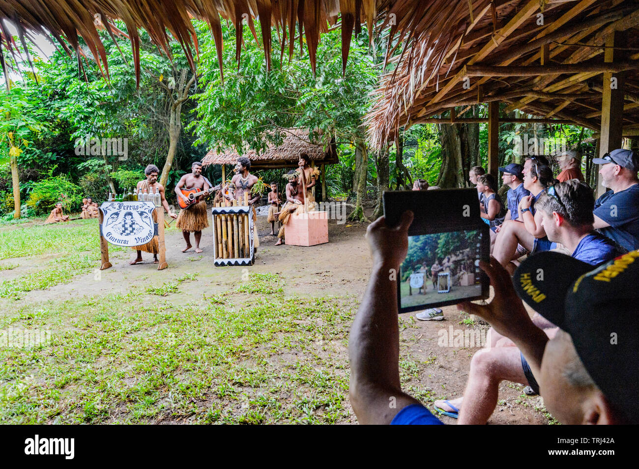 Touristen beobachten und die Bilder von einem singenden Demonstration am Pepeyo Cultural Village, Port Vila, Efate Island, Vanuatu, Melanesien Stockfoto