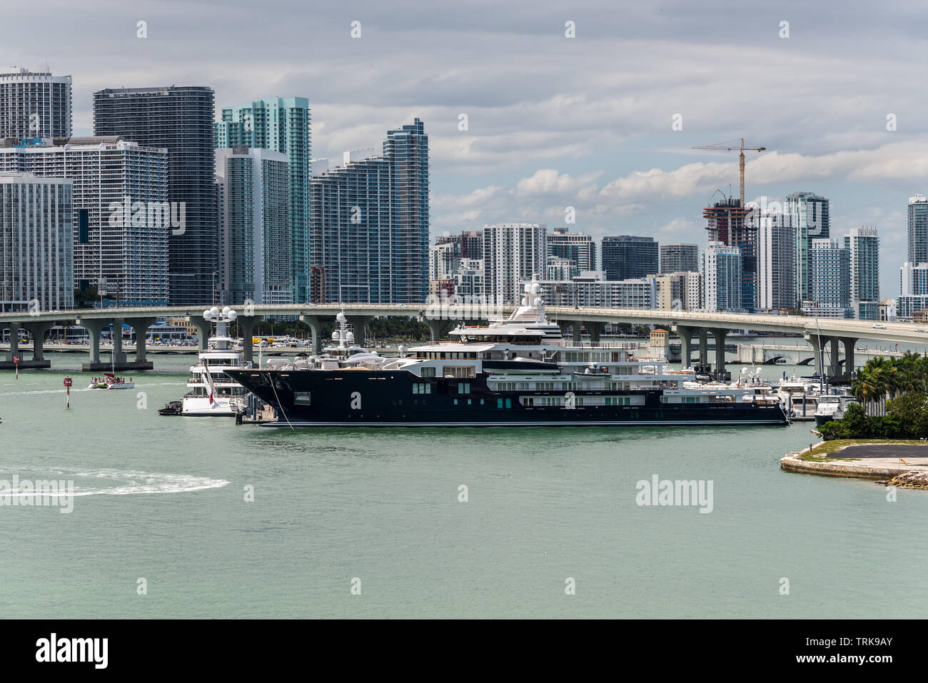 Miami, FL, Vereinigte Staaten - 20 April, 2019: Miami Skyline von Dodge Island an der Biscayne Bay gesehen. Lange Verkehr Brücke und Luxus Yacht in der Fo Stockfoto
