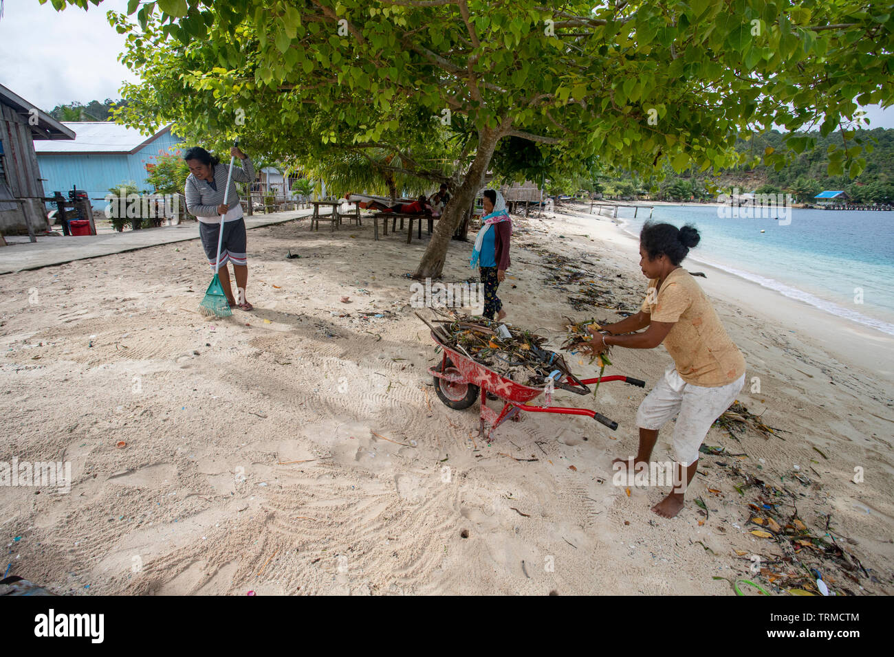 Insel Papua Dorfbewohner Clearing bis Kunststoff marine Müll am Strand gedumpten in Manyaifun während einer windigen Tag auf der Insel Batang Pele, West Wa Stockfoto