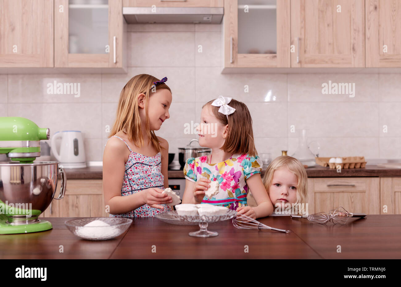 Große Familie - eine Mutter und drei Kinder, zwei Töchter und einen Sohn, in der Küche kochen, Sahne in einen Mixer. Selektive konzentrieren. Stockfoto