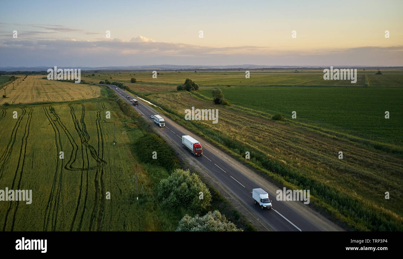 Lkw-Fahrten im Sommer auf der Straße bei Sonnenuntergang Stockfoto
