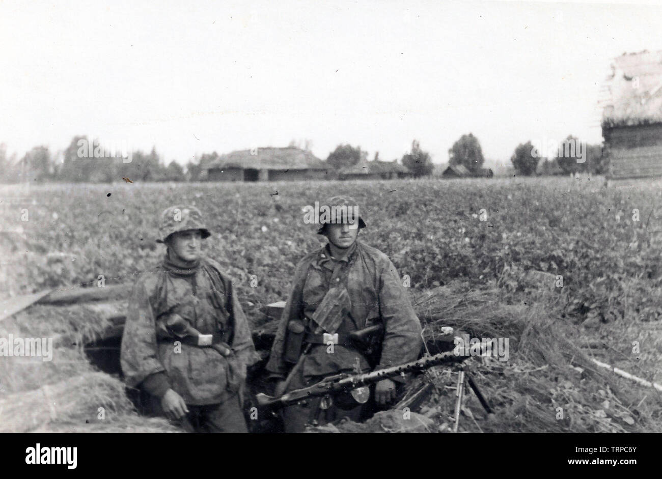 Zwei Waffen-SS-Männer in der Tarnung Kittel aus der 2. SS Panzer Division Das Reich in einen Graben mit einem leichten MG an der russischen Front 1941 Stockfoto