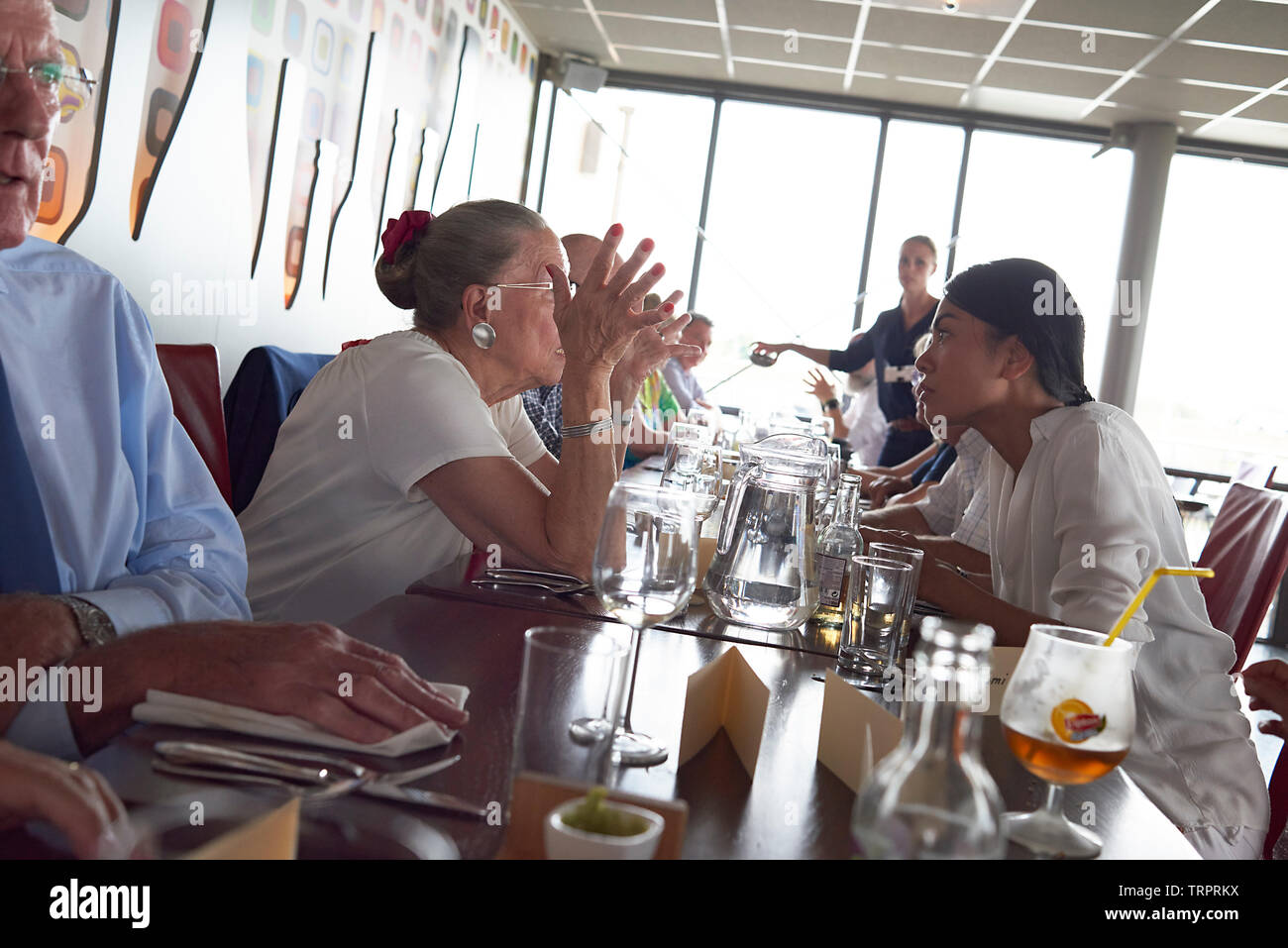 Eine Gruppe von älteren pensionierten Freunde feiert 50. Hochzeitstag in einem Restaurant mit viel Lachen, Reden, Geschenke und Freude Stockfoto