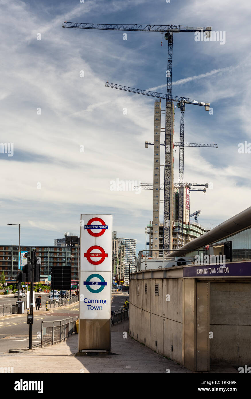 London, England, Großbritannien - 1. Juni 2019: Baukräne Turm über die Canning Town U-Bahn und dem DLR Station während einer Hochkonjunktur im Hochhaus Gehäuse Stockfoto