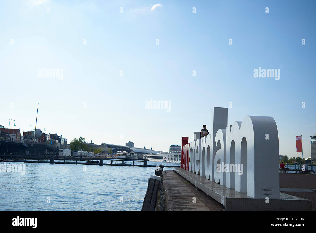 Kinder spielen auf der Oberseite des iamsterdam Zeichen in das Stadtzentrum von Amsterdam im Sommer Sonnenschein Stockfoto