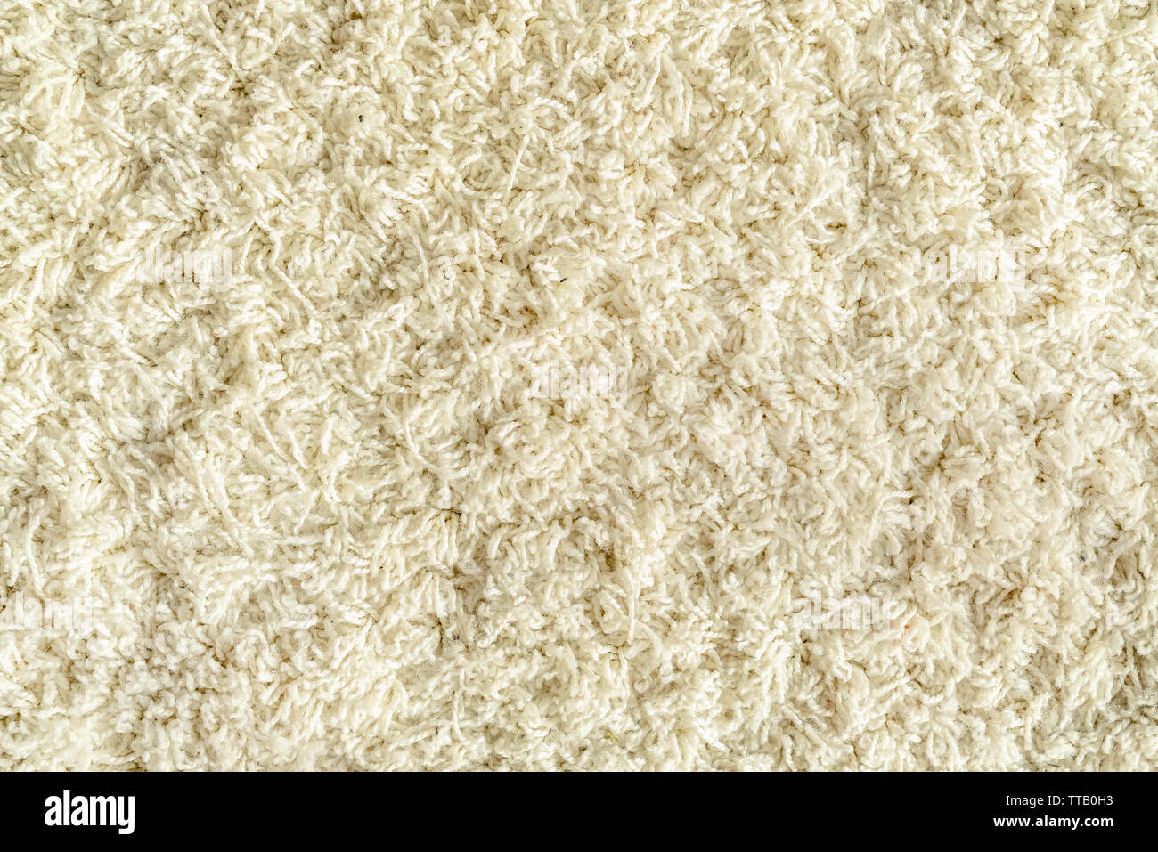 Textur von einem weissen Teppich mit langem Flor Stockfoto