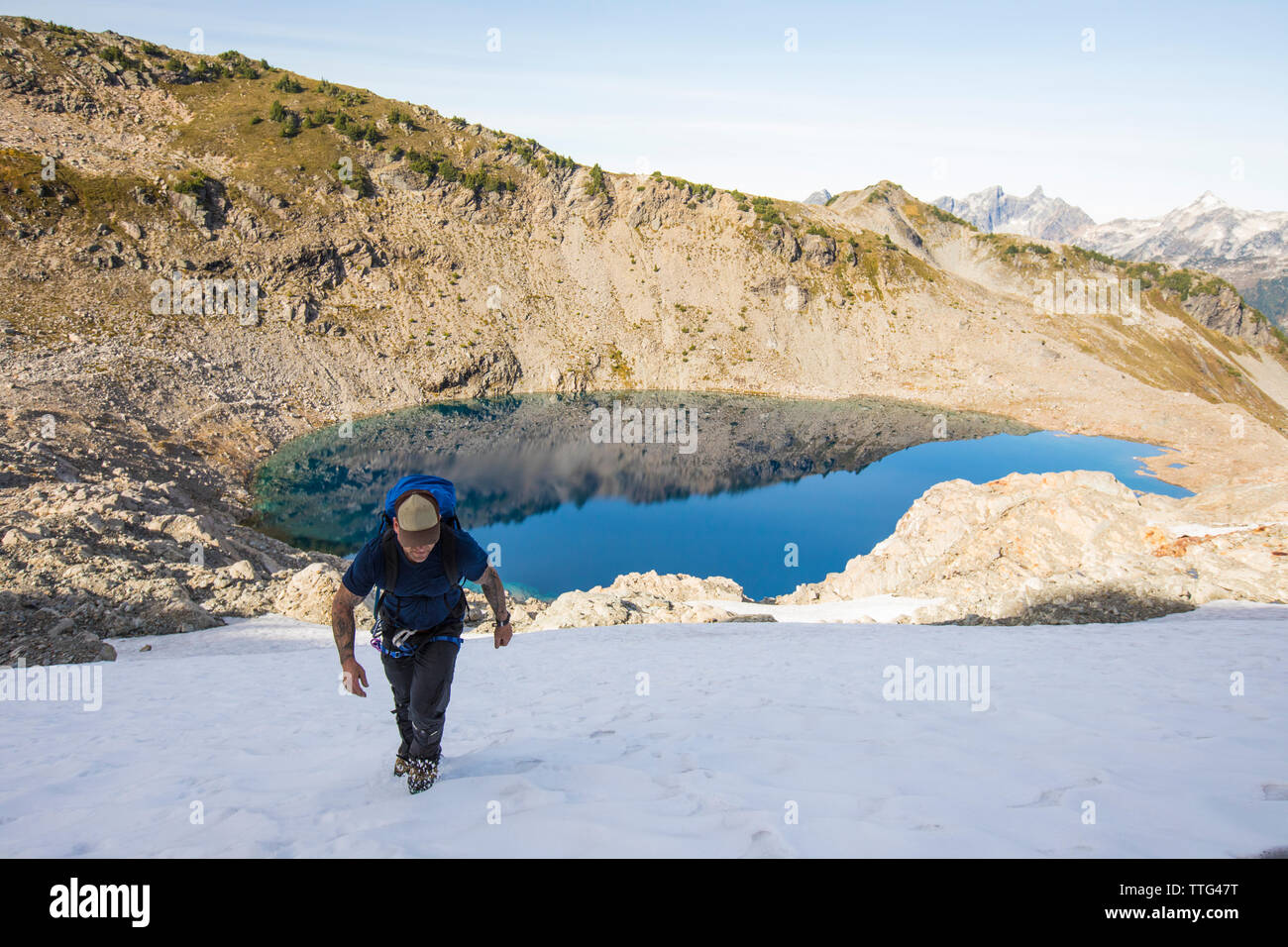 Ein solo Bergsteiger steigt ein Schnee patch en route Douglas Peak, B.C. Stockfoto