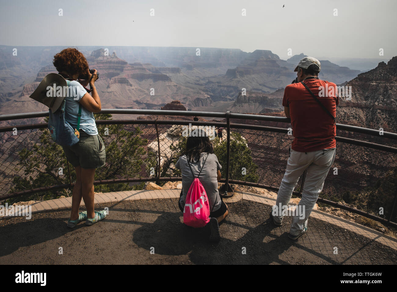 Drei Menschen fotografieren des Grand Canyon aus der Sicht Stockfoto