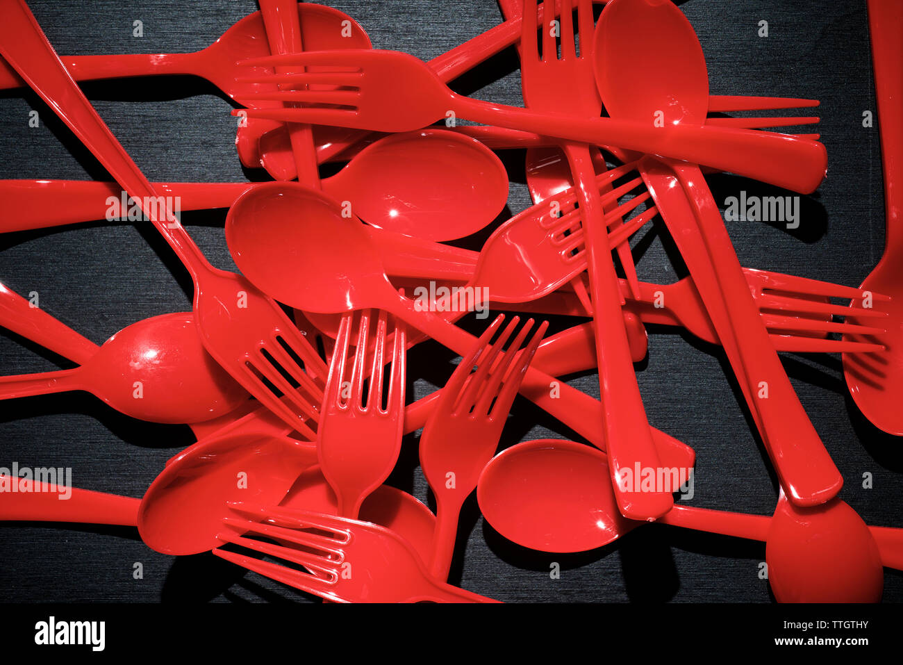 Rot aus Kunststoff Besteck auf einer schwarzen Tisch. Stockfoto
