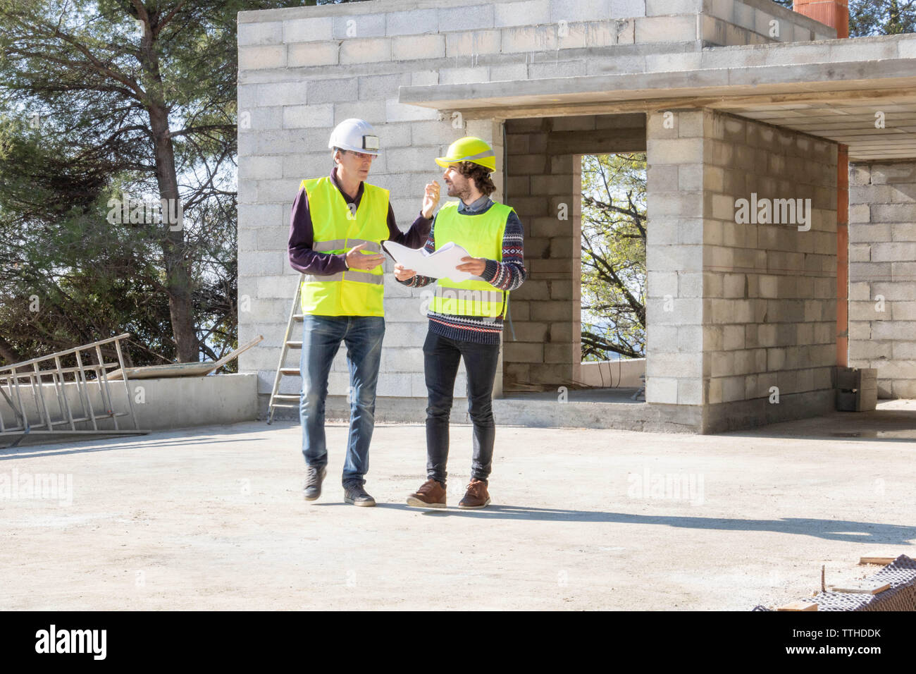 Baustelle besuchen, Haus im Bau: Architekt und Vorarbeiter im Gespräch Stockfoto
