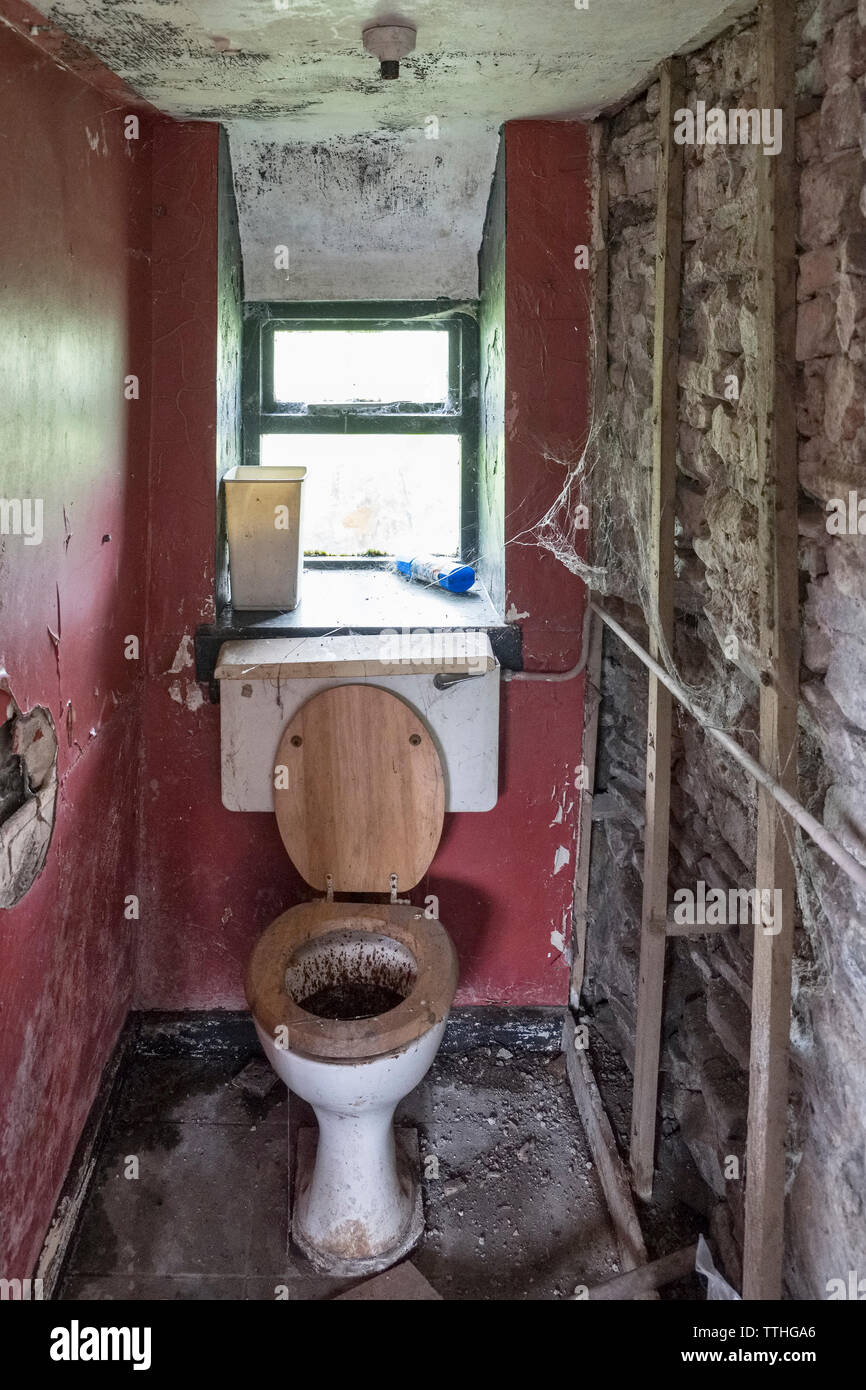 Eine schmutzige Toilette in einem alten Haus für Verkauf Stockfoto