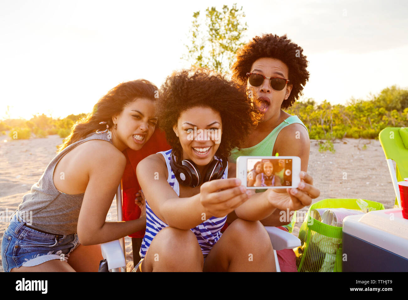 Gerne Freunde unter selfie auf Handy am Strand Stockfoto