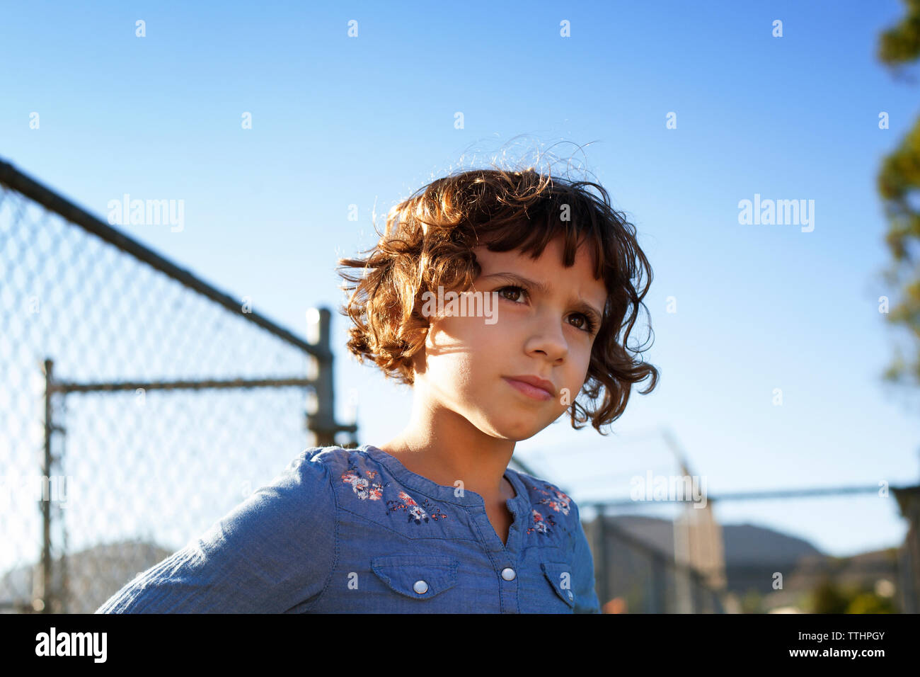 Mädchen weg schauen, während gegen den klaren Himmel stehen Stockfoto