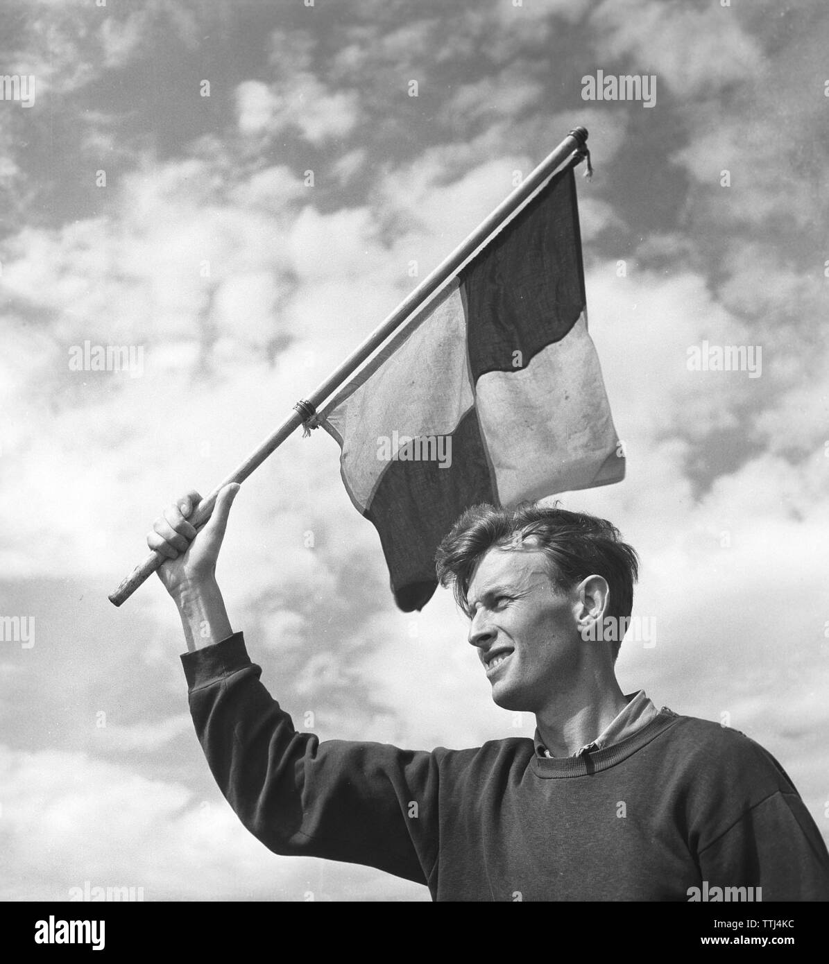 Erste Schritte. Ein junger Mann mit einer Flagge in der Hand und er konnte eine Rasse, oder Winken auf der finishline, wenn das Rennen vorbei ist. Schweden 1954. Kristoffersson ref BP 56-2 Stockfoto