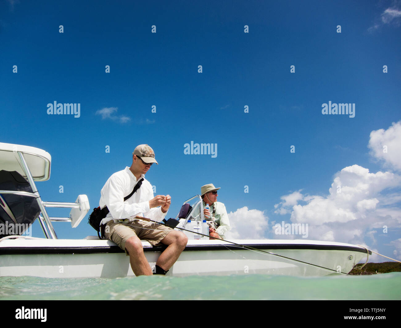 Freunde sitzen auf dem Motorboot im Meer Stockfoto