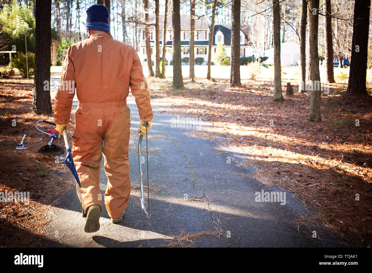 Ansicht der Rückseite des Mann, Gartengeräte im Wald Stockfoto