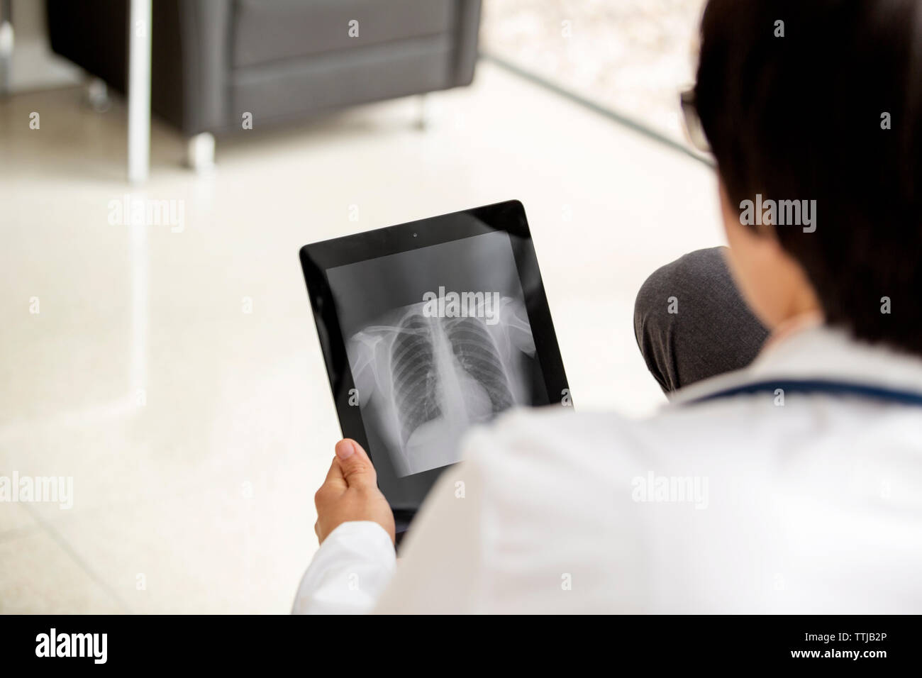 Ansicht der Rückseite des Ärzte suchen x-ray Bericht in Tablet-PC Stockfoto