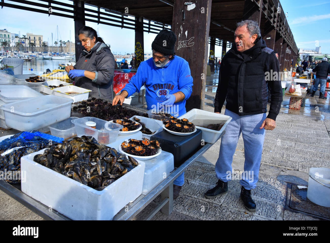 BARI, ITALIEN - 9. FEBRUAR 2019. Menschen arbeiten und die Vorbereitung der Seeigel am Fischmarkt von Bari an der Adria, Region Apulien, südlichen Ita Stockfoto