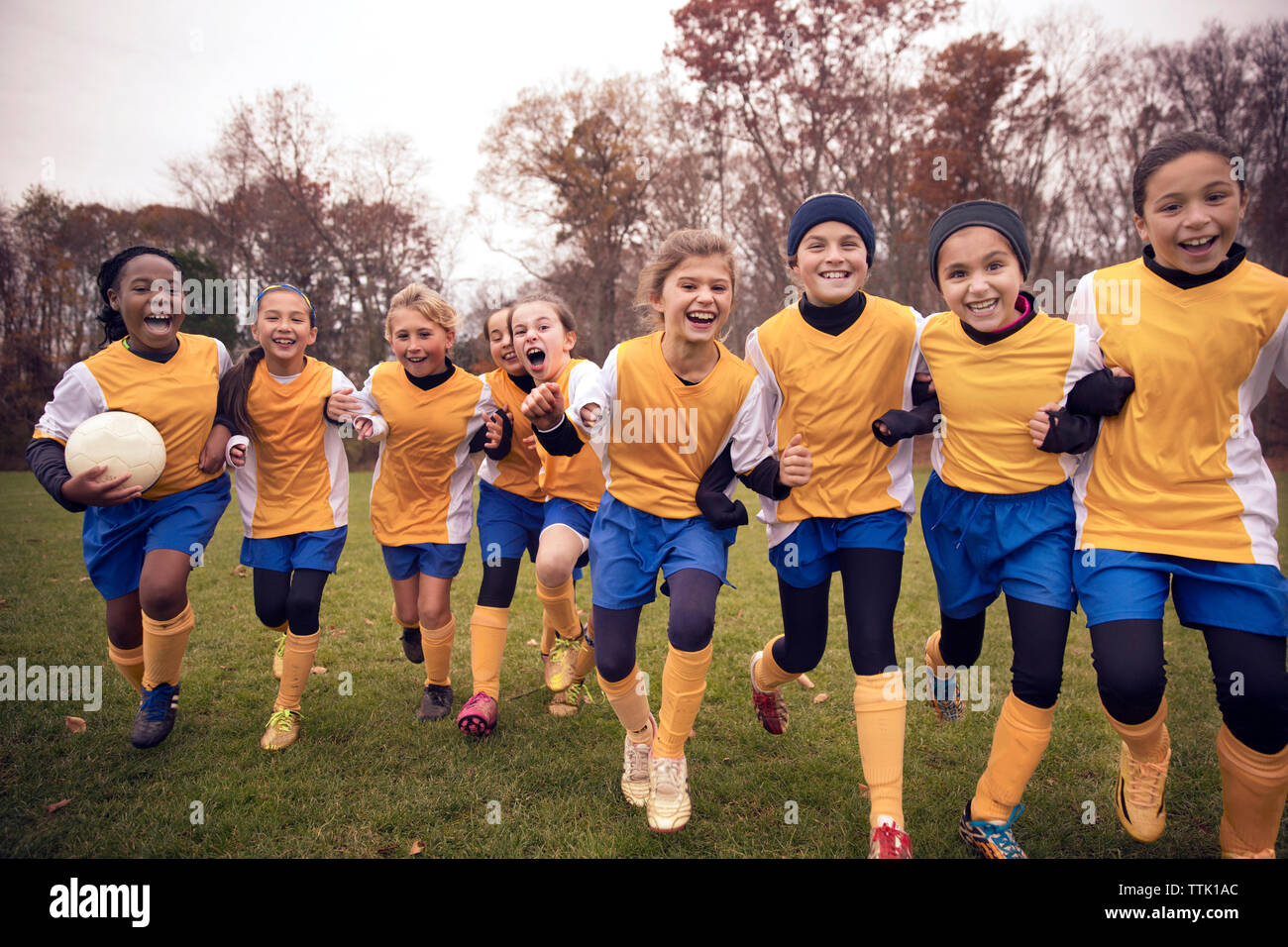 Weibliche Fußballmannschaft genießen auf dem Spielfeld begeistert Stockfoto