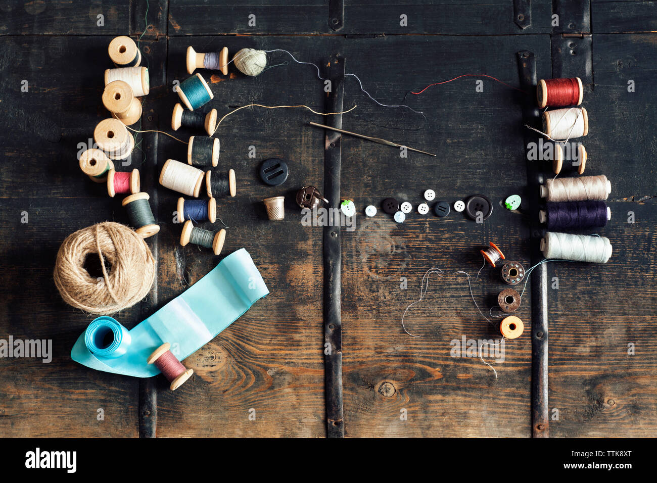 Ansicht von oben der Nähtechnik mit Gewinde Rollen auf hölzernen Tisch Stockfoto
