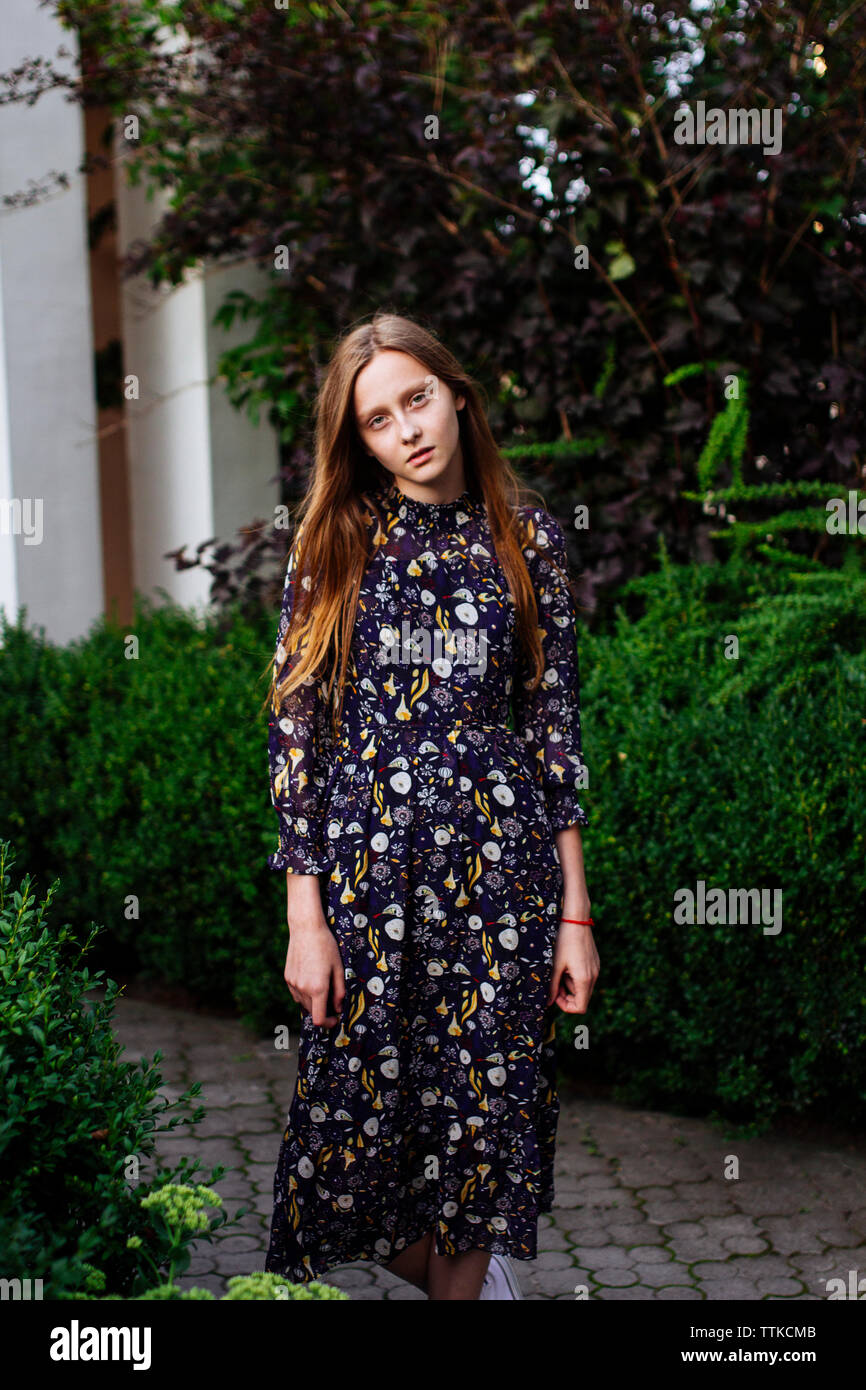 Frau, die in der Nähe der Sträucher Buchsbaum Stockfoto