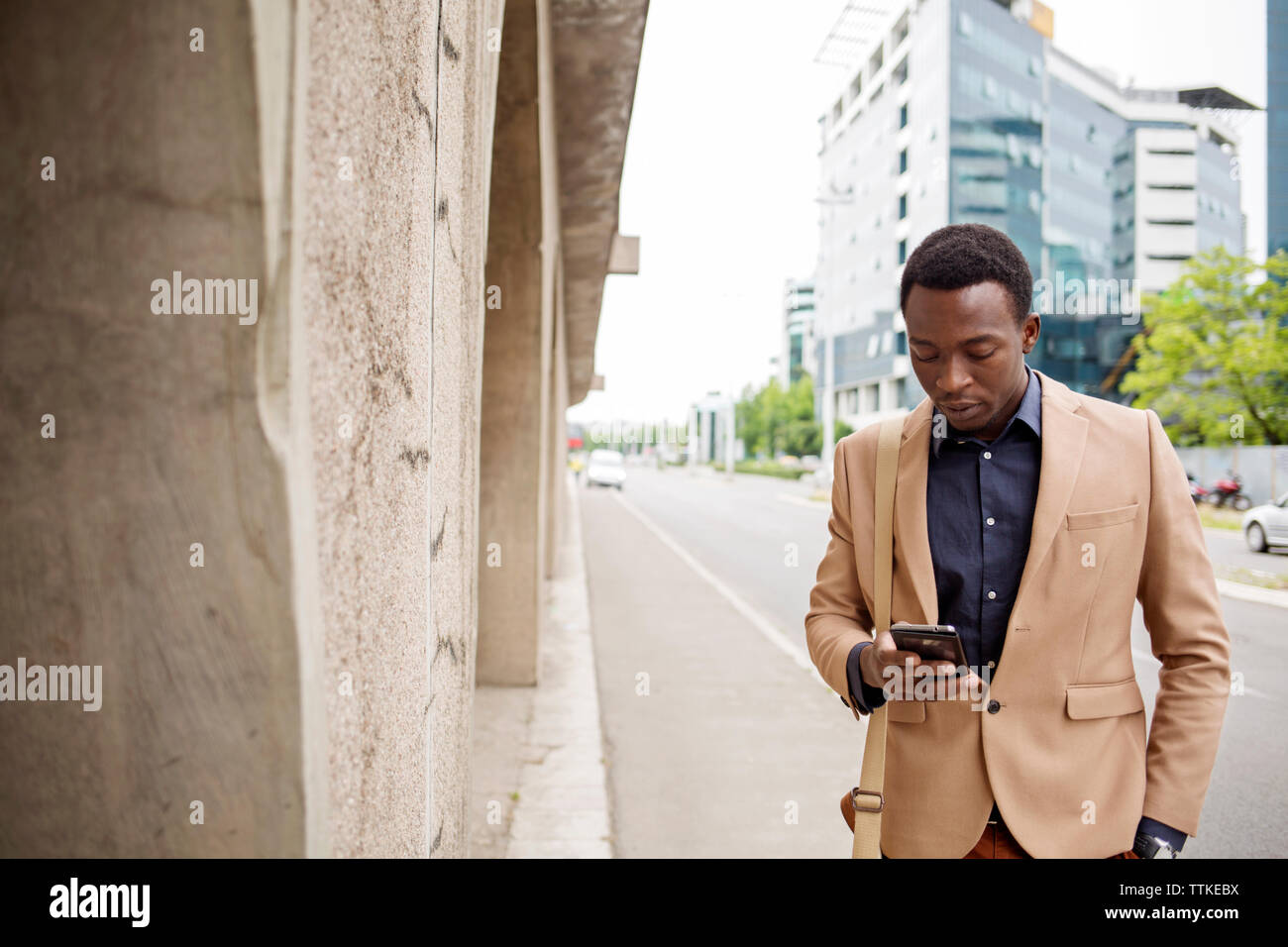 Geschäftsmann mit Smartphone auf der Straße der Stadt Stockfoto