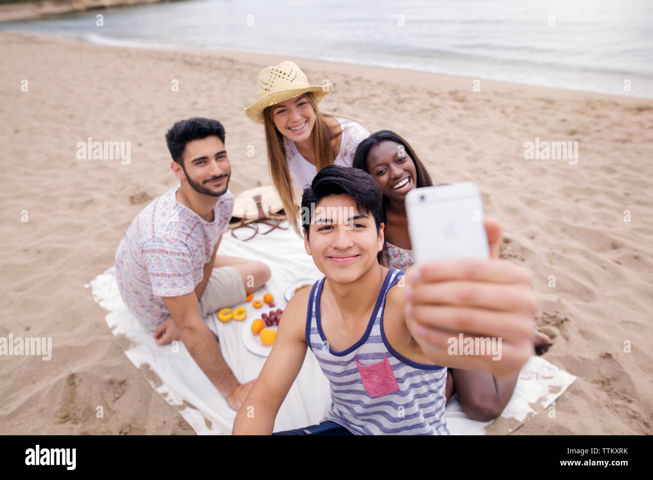 Freunde von selfie und geniessen Sie ein Picknick am Strand. Stockfoto