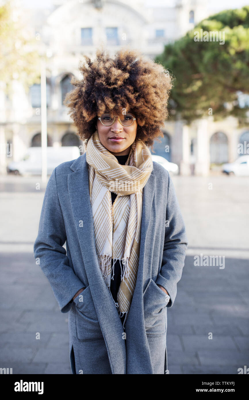 Portrait von selbstbewusste Frau mit Händen in den Taschen auf Stadt Stockfoto