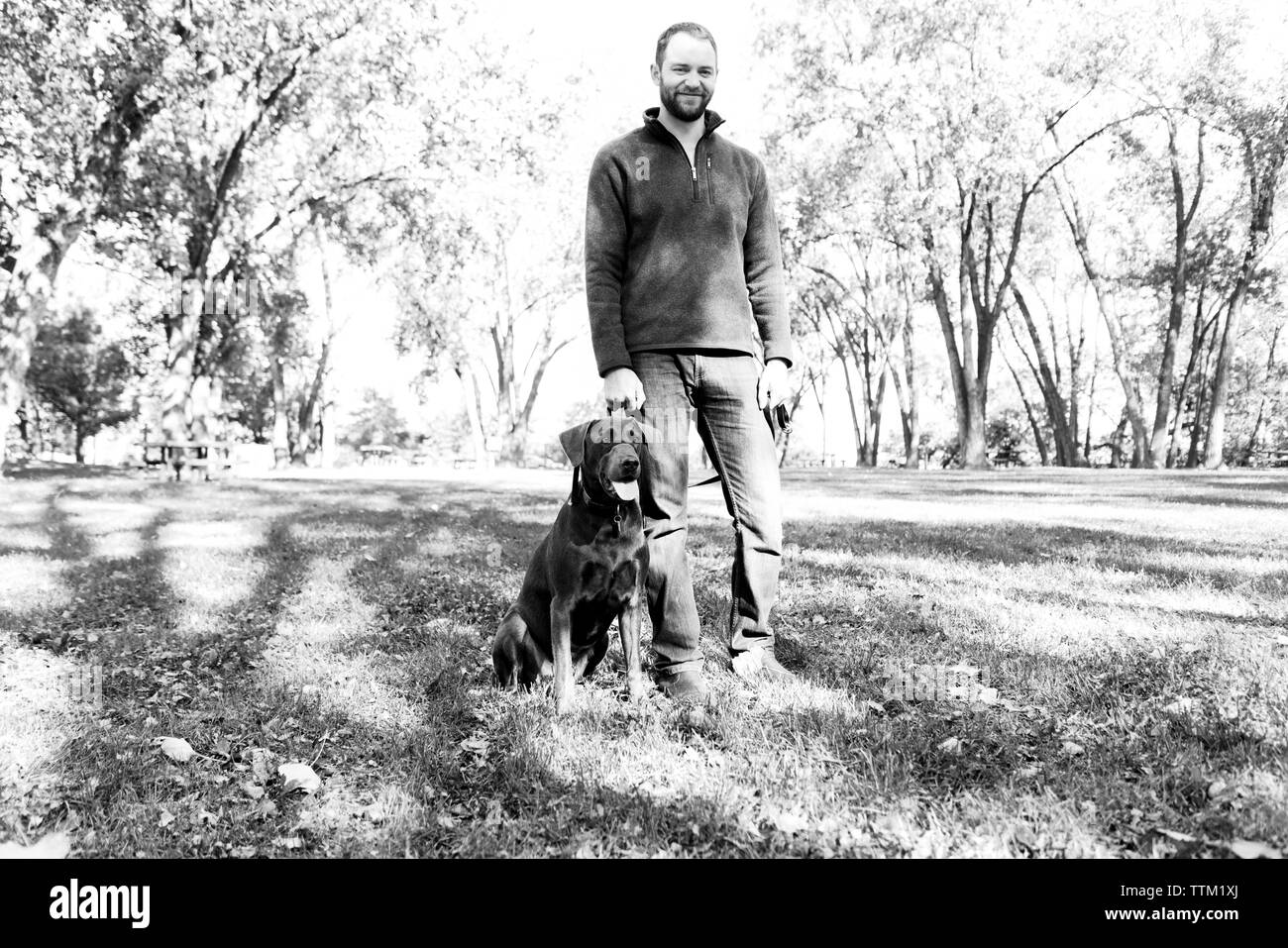 Ein Schwarz-Weiß-Porträt eines Mannes und sein Hund Stockfoto
