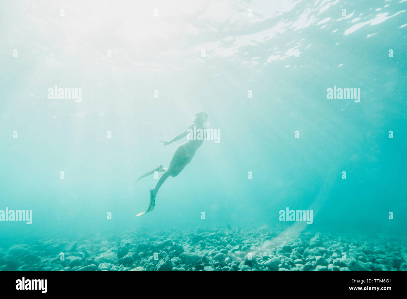 Low Angle View von Frau schwimmen Undersea Stockfoto