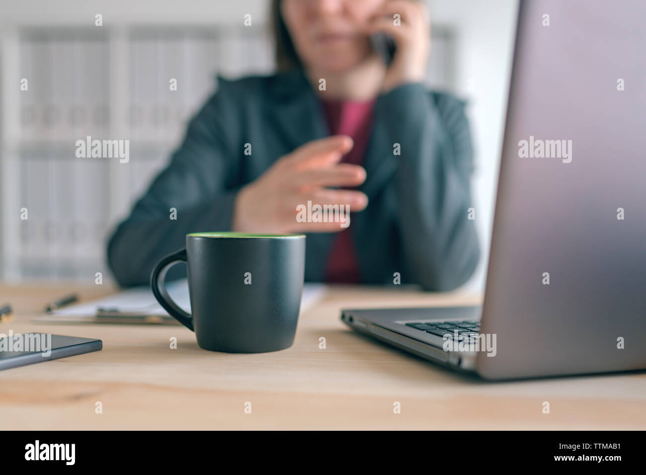 Geschäftsfrau Gespräch am Handy während der Kaffeepause im Büro. Elegante Hündin business Person mit Smartphone und Kaffee Tasse. Stockfoto